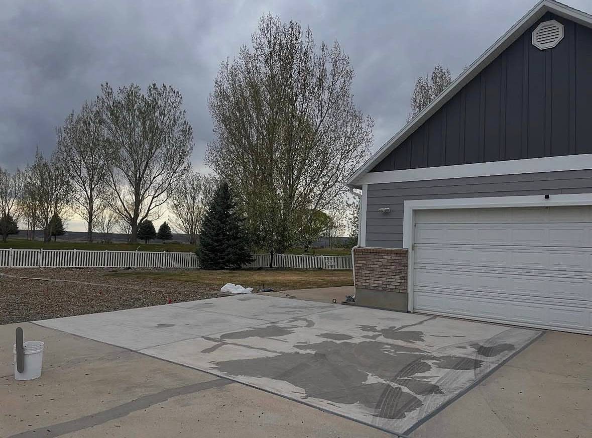 Driveway slab in Roosevelt, Utah, with damp patches as it cures