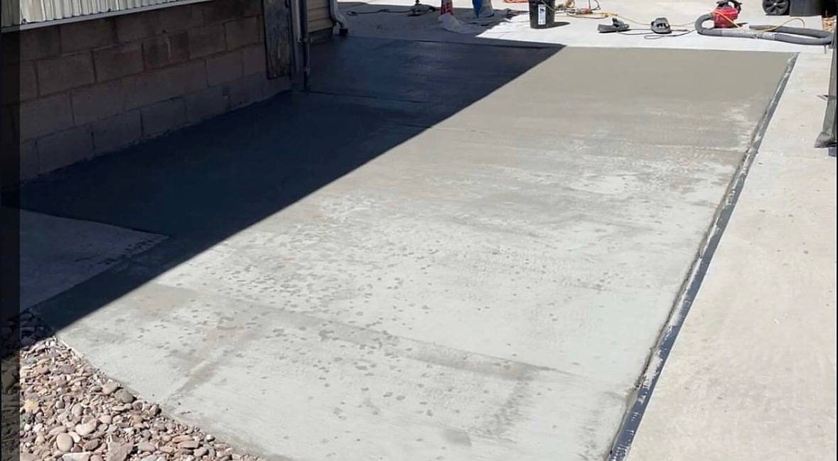 A fresh concrete surface going down along a building